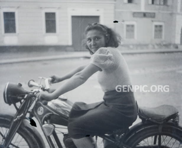 Young woman on motorbike.